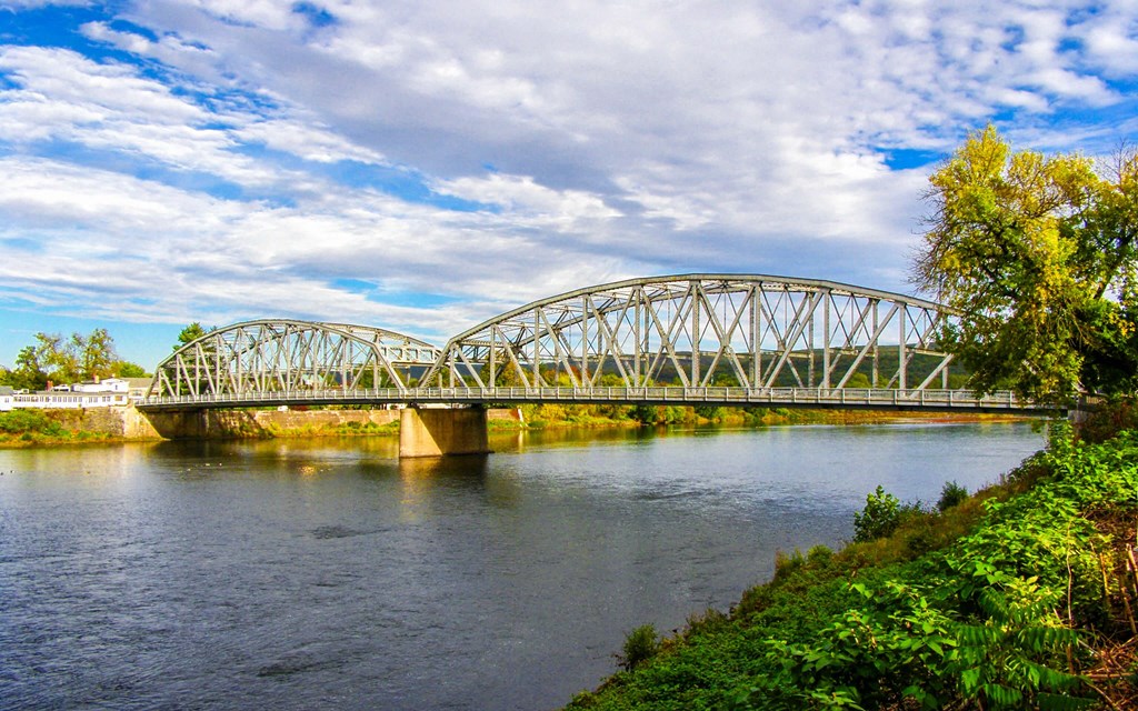 a bridge over a river on a cloudy day