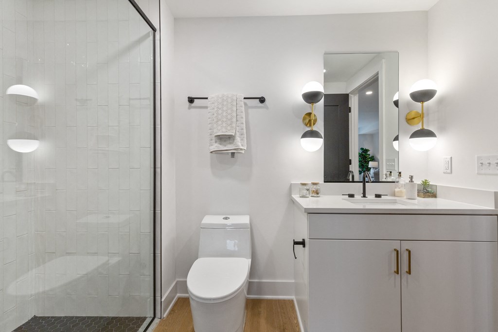 a white bathroom with a shower and a sink and a toilet at Rialto, Washington, DC 20002