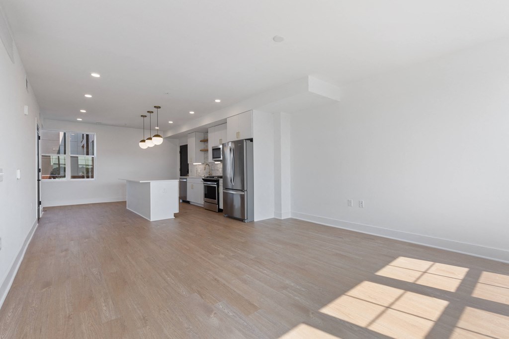 a renovated living room with a kitchen and a hard wood floor at Rialto, Washington
