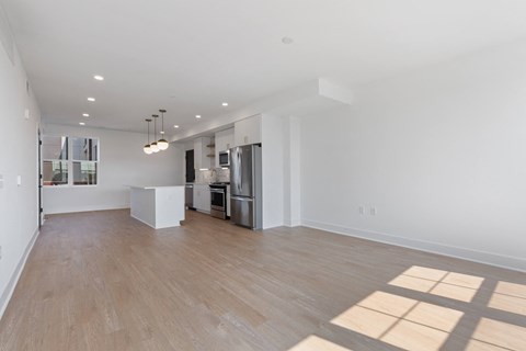 a renovated living room with a kitchen and a hard wood floor at Rialto, Washington