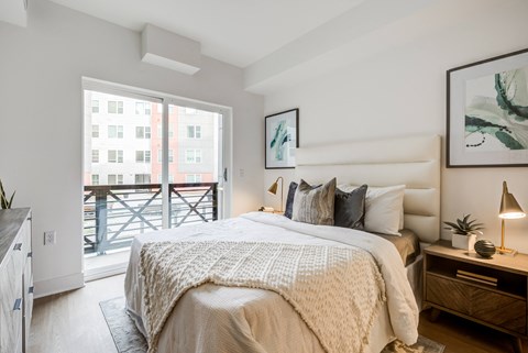 a bedroom with a bed and a sliding glass door to a balcony at Rialto, Washington District of Columbia
