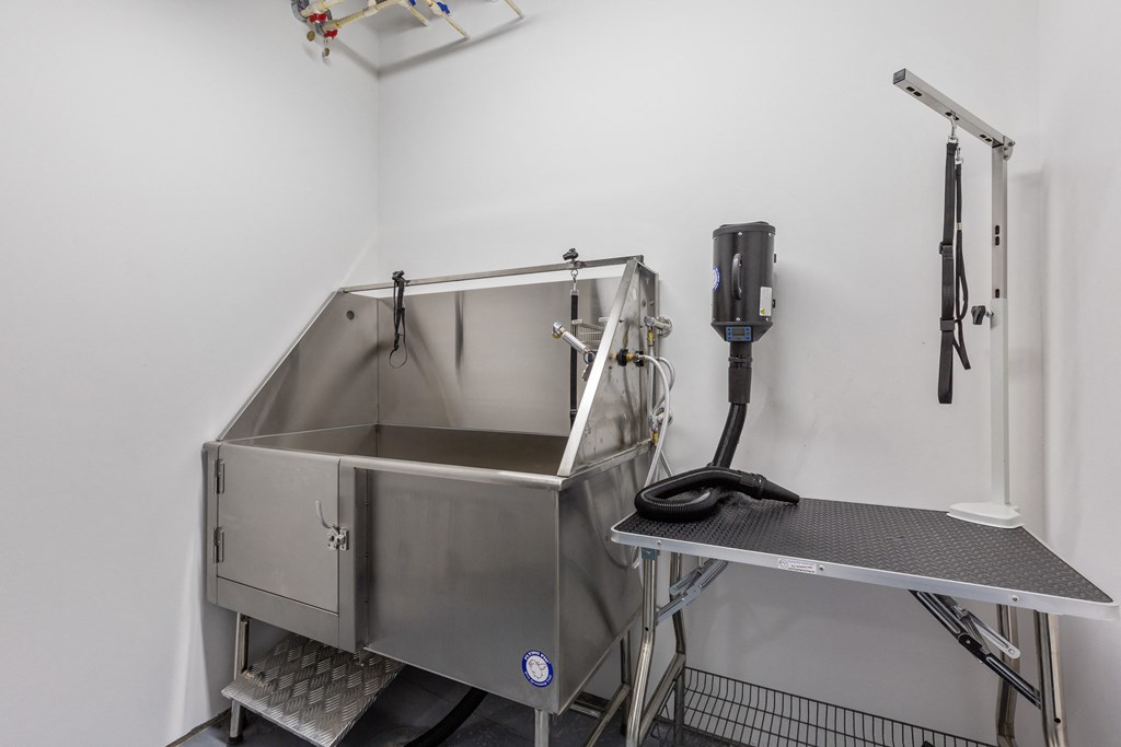 a stainless steel sink in a room with a phone on the wall at Rialto, District of Columbia