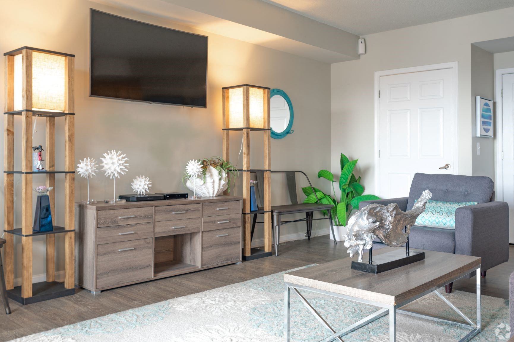 a living room filled with furniture and a flat screen tv  at The Redwood, Baltimore, MD
