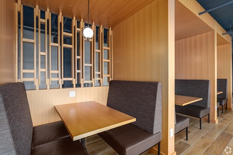 a dining room with wooden walls and a table and chairs