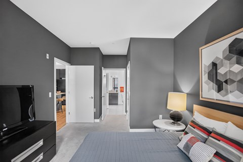 A modern bedroom with a large bed and a television.