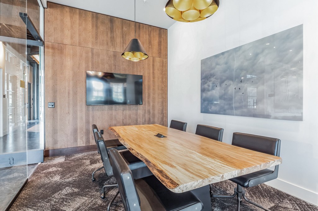 a long wooden table in a restaurant with glass walls at South and Hollis, Charlotte, 28209
