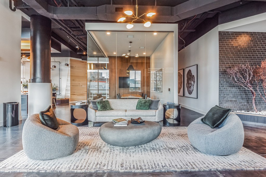a living room with couches and chairs and a rug at South and Hollis, Charlotte