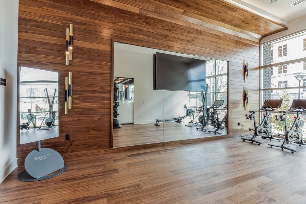 a gym with wood floors and a tv on the wall at South and Hollis, Charlotte, North Carolina