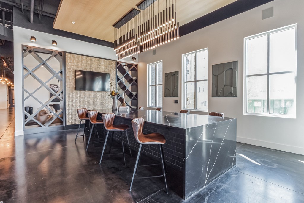 a kitchen with a marble counter top and a dining room with chairs at South and Hollis, Charlotte, NC, 28209