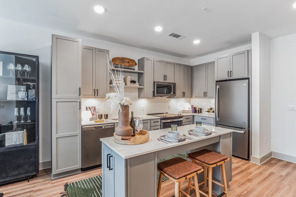 a kitchen with a large island and stainless steel appliances at South and Hollis, North Carolina, 28209