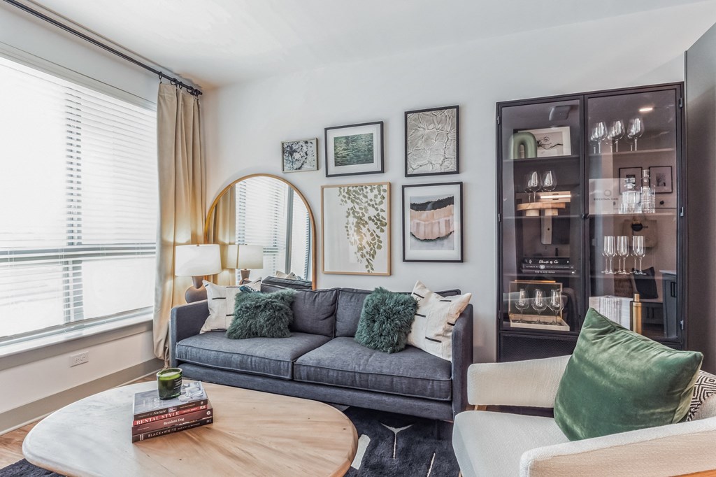 a living room with a gray couch and a coffee table at South and Hollis, Charlotte