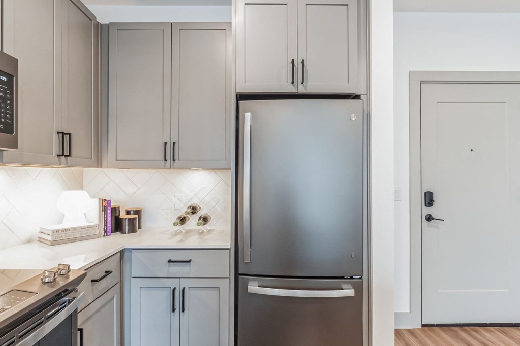 a kitchen with white cabinets and a stainless steel refrigerator at South and Hollis, Charlotte, NC, 28209
