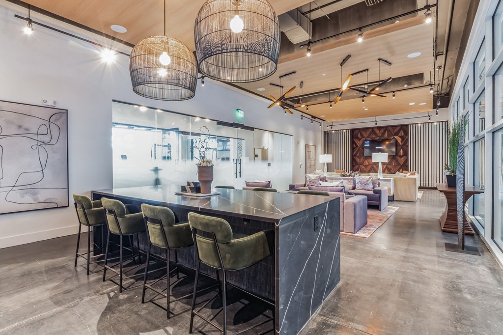 the lobby of a restaurant with a long bar and chairs at South and Hollis, Charlotte, 28209