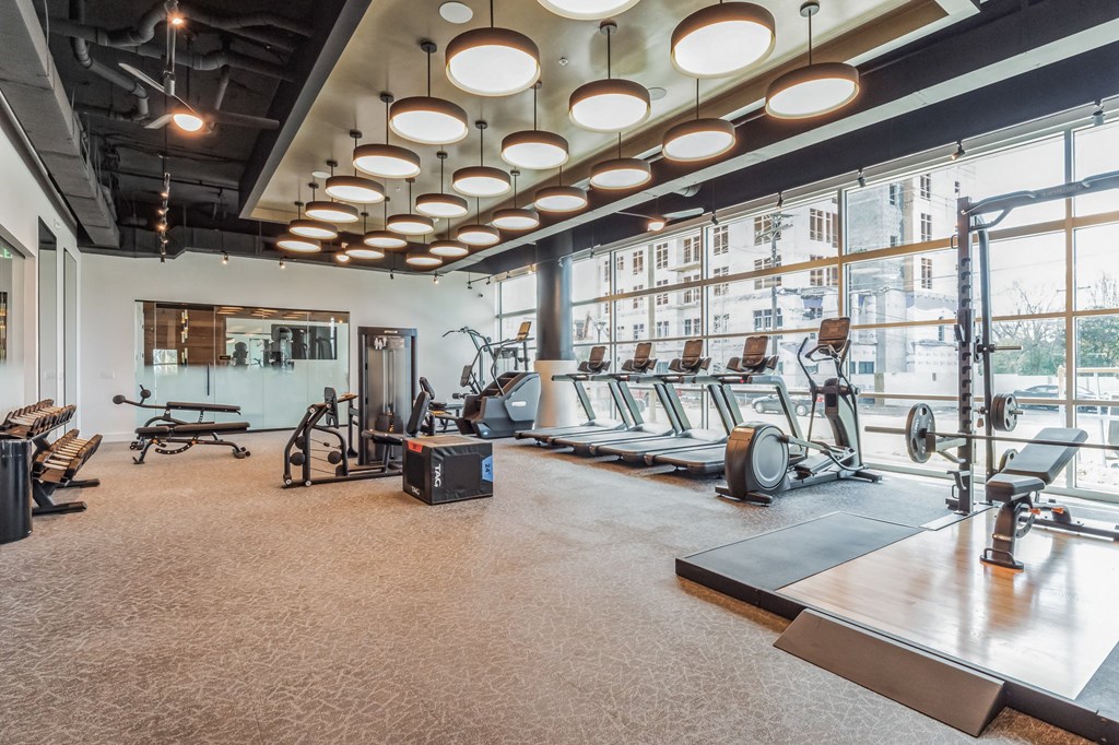 a gym with exercise equipment and large windows at South and Hollis, Charlotte, NC, 28209