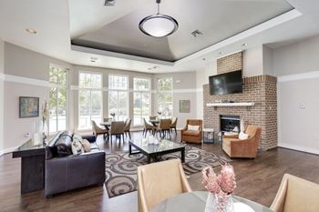 a living room with a fireplace and a table with chairs