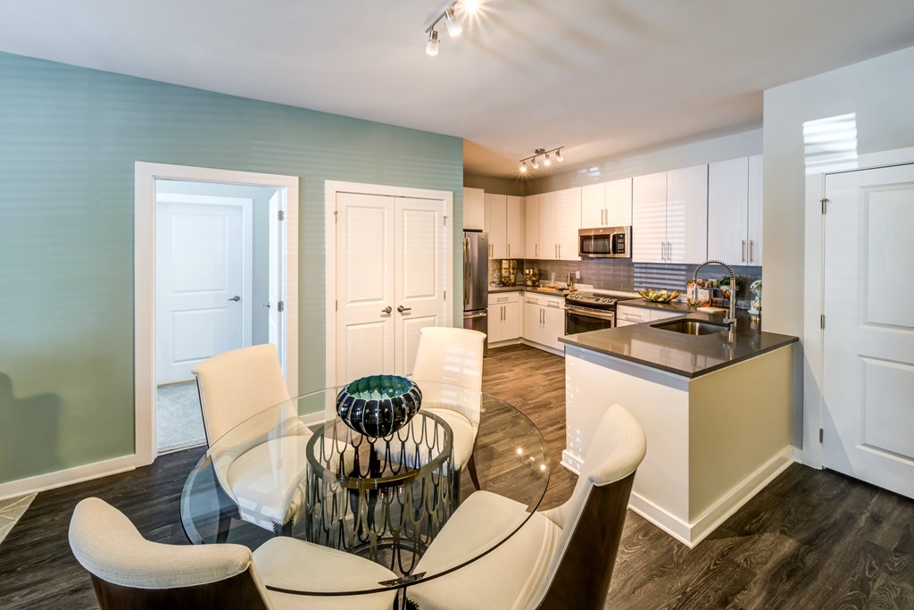 A Kitchen With a Glass Table at The Aster Apartments, Cary, North Carolina