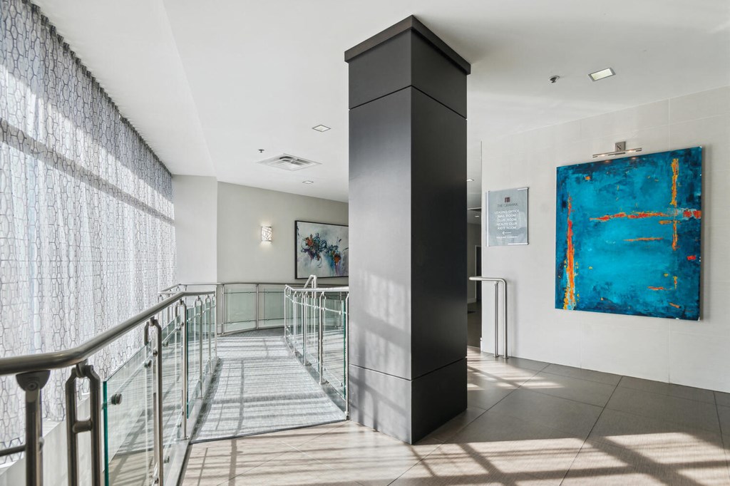 the lobby of a building with stairs and a blue painting at The Gramax, Silver Spring, Maryland