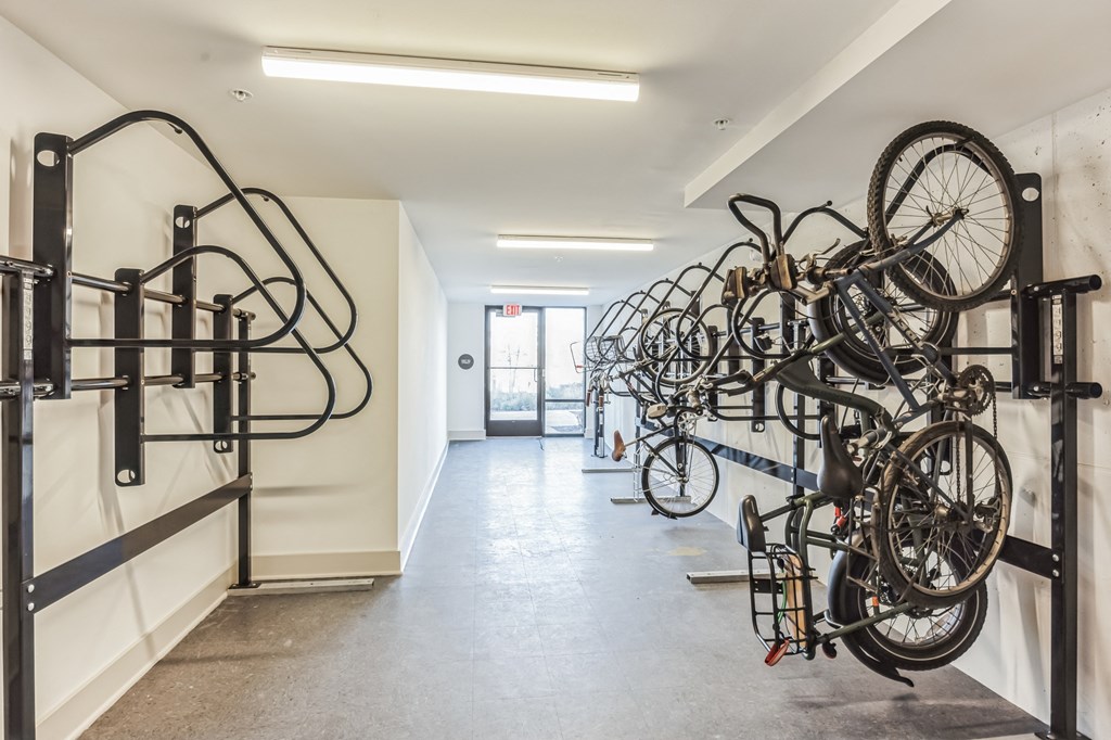 a row of bikes hanging on a wall in a white room at Metropolitan at the Riverwalk, Wilmington, 28401