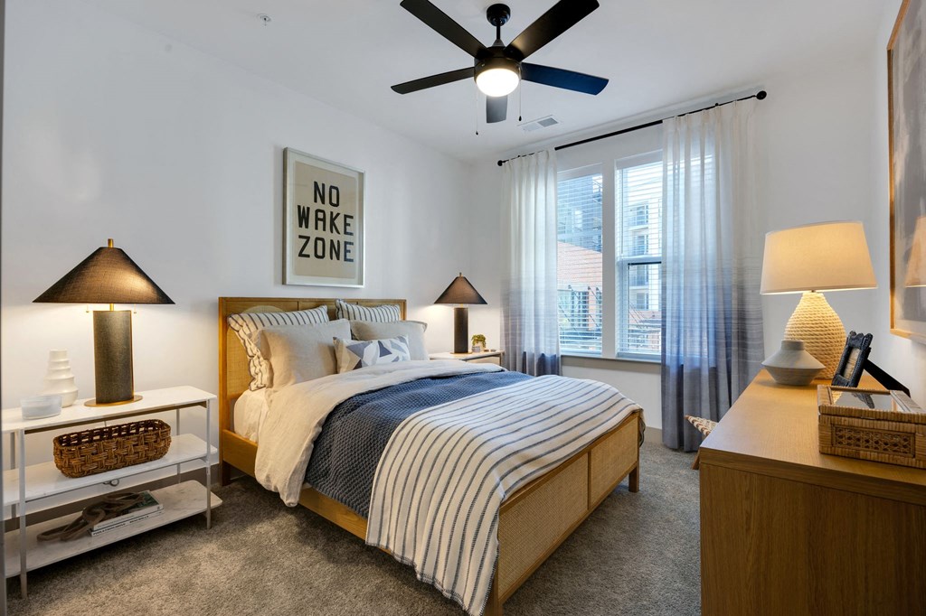 a bedroom with a bed and a ceiling fan at Metropolitan at the Riverwalk, Wilmington North Carolina