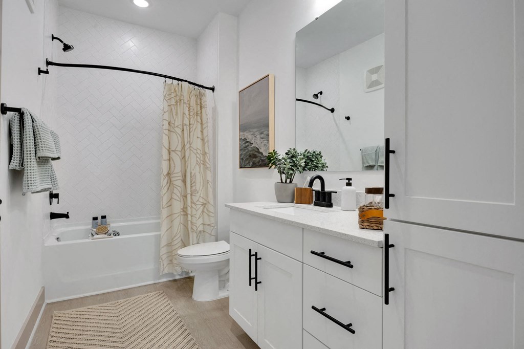 a white bathroom with a shower and a toilet at Metropolitan at the Riverwalk, Wilmington
