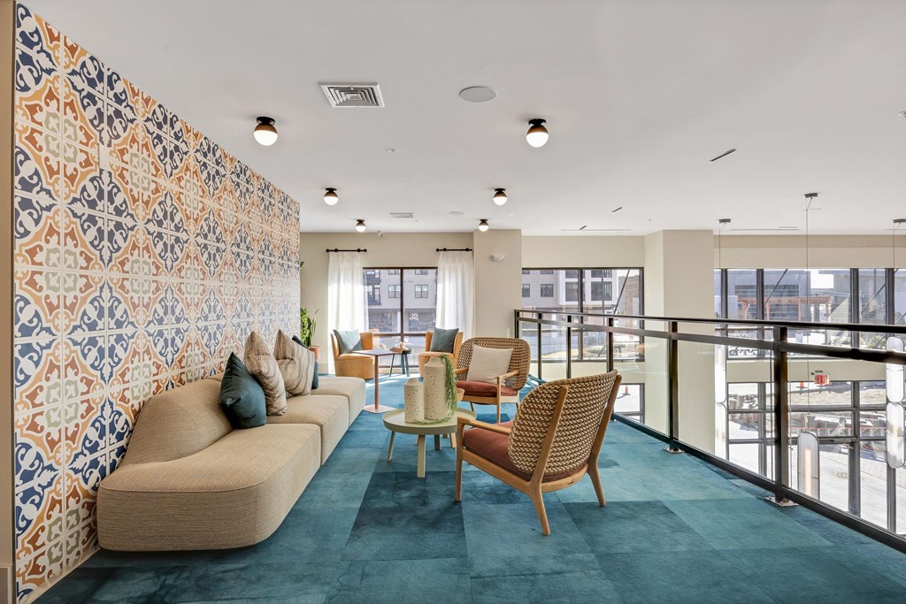 a living room with a couch and chairs and a balcony at Metropolitan at the Riverwalk, Wilmington, 28401