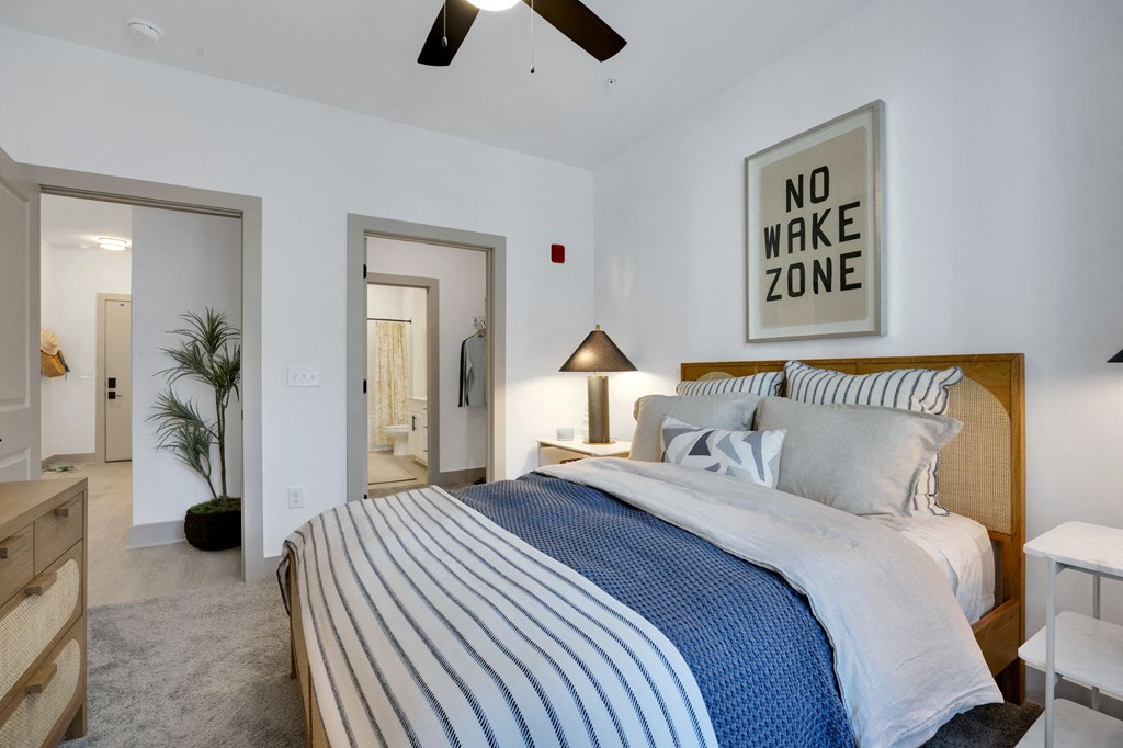 a bedroom with a bed and a ceiling fanat Metropolitan at the Riverwalk, Wilmington North Carolina