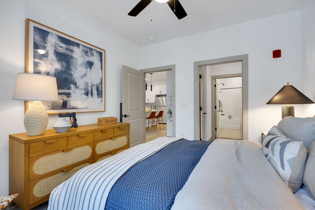 a bedroom with a large bed and a painting on the wall at Metropolitan at the Riverwalk, North Carolina