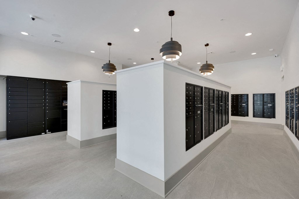 the tasting room has a wall of wine racks and a large white wall with lights at Metropolitan at the Riverwalk, Wilmington, NC 28401
