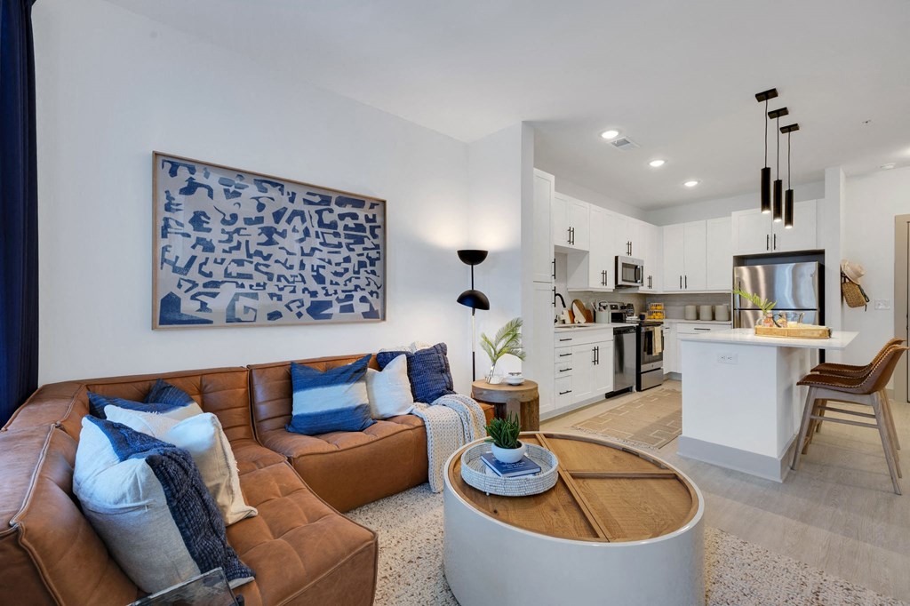 a living room with a couch and a table  at Metropolitan at the Riverwalk, Wilmington, 28401