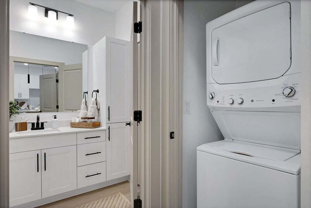 a laundry room with a washer and dryer and a sink at Metropolitan at the Riverwalk, Wilmington, 28401