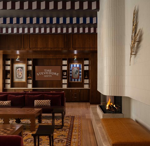 A cozy room with a fireplace and a sign that says "The Steeves".