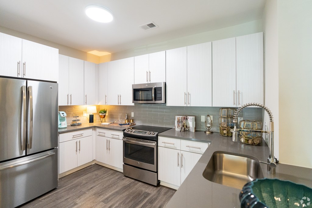 A Kitchen With White Cabinets at The Aster Apartments, North Carolina