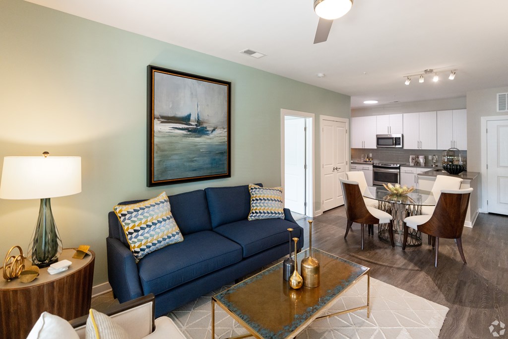 A Living Room With a Blue Couch at The Aster Apartments, Cary