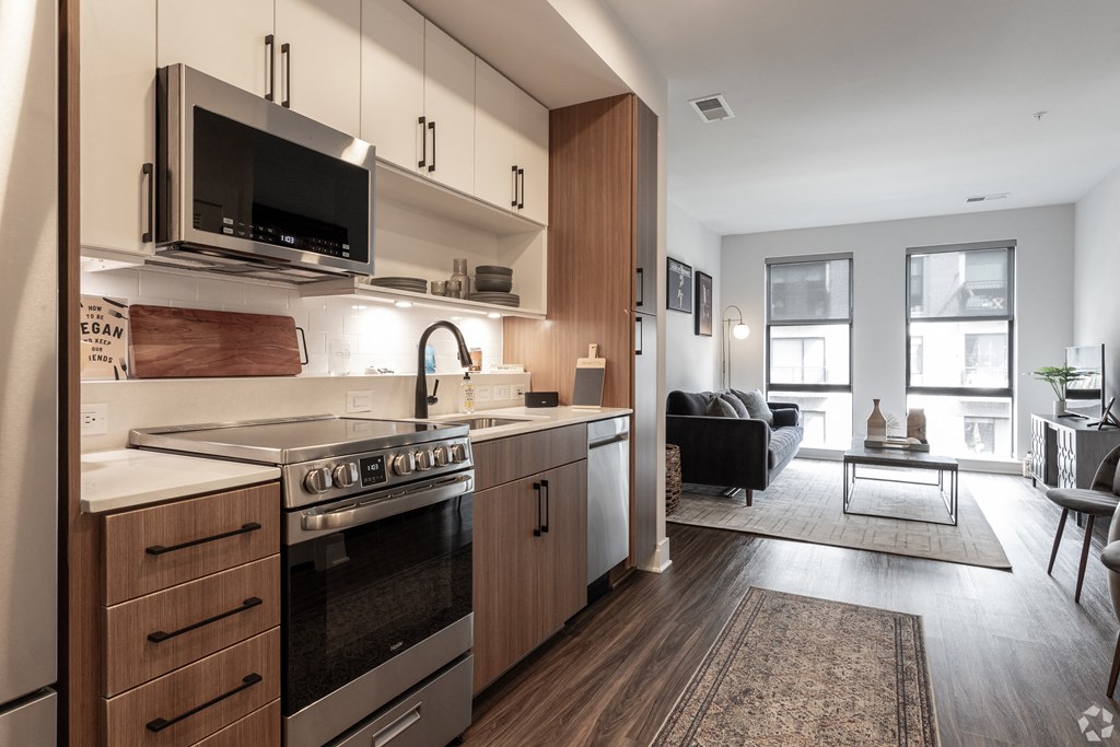 a kitchen with wooden cabinets and a stove and a microwave