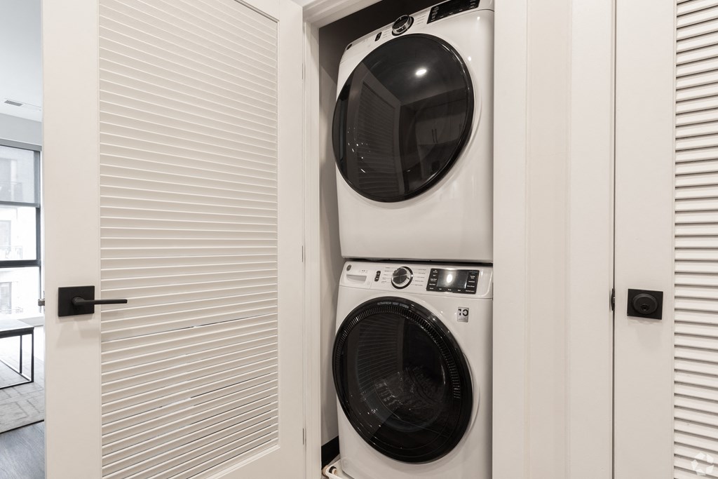 a front loading washer and dryer in a laundry room