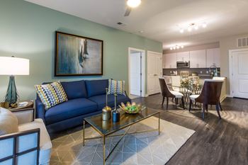 A Living Room With a Painting on The Wall at The Aster Apartments, Cary