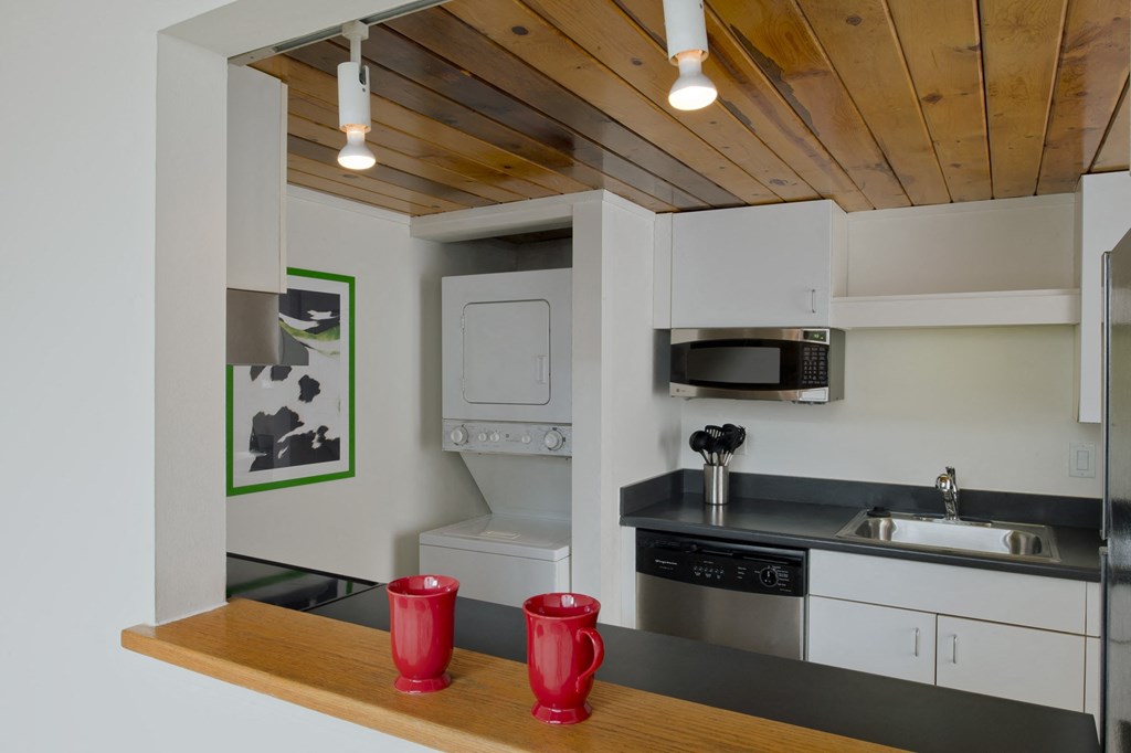 a kitchen with white cabinets and a sink and a microwave at Tindeco Wharf, Baltimore, 21224