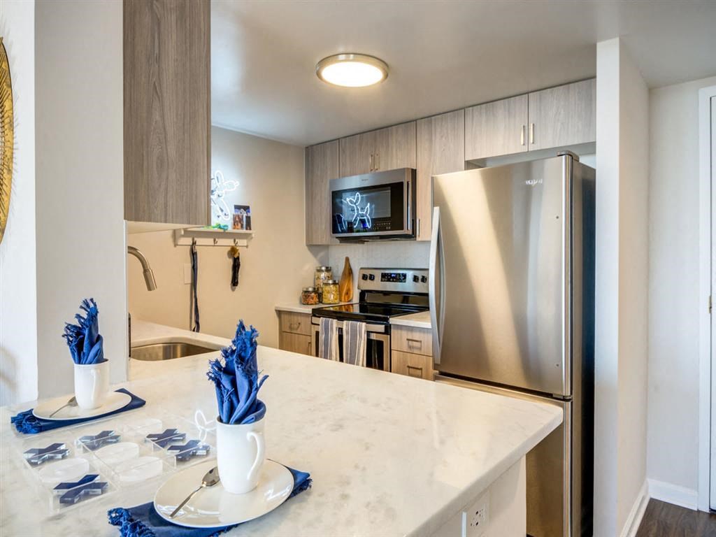 a kitchen with stainless steel appliances and a counter top at Lincoln Old Town, Alexandria, 22314