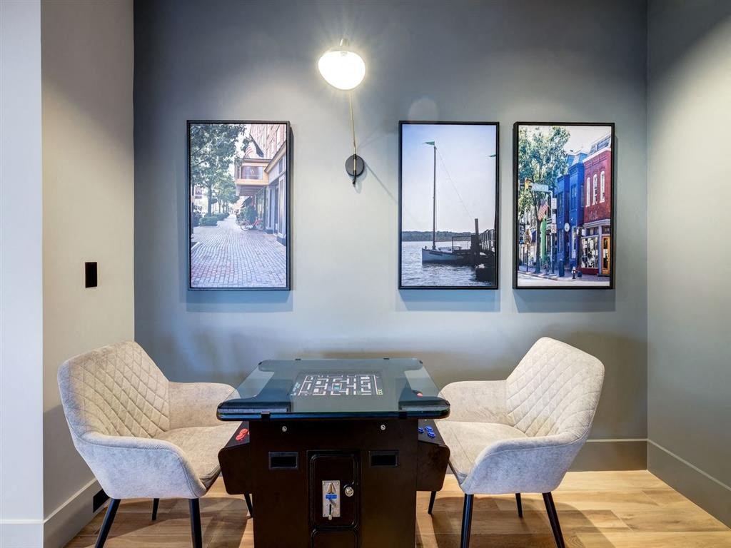 a home office with a desk and chairs and pictures on the wall at Lincoln Old Town, Alexandria