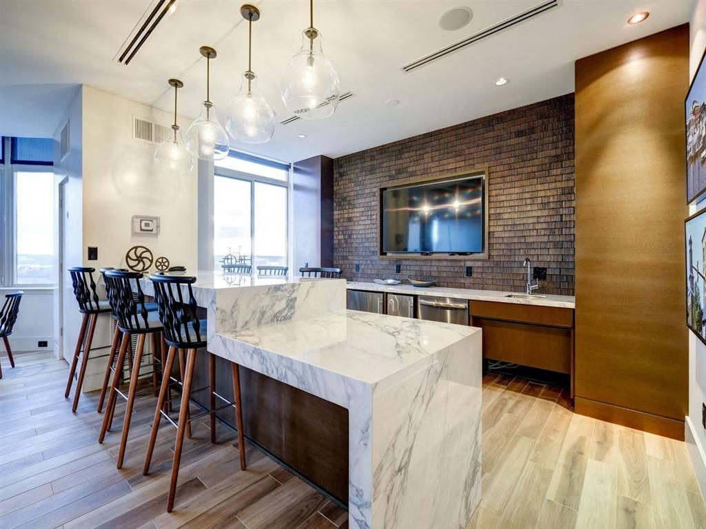 a kitchen with a marble counter top and bar stools at Lincoln Old Town, Alexandria, VA