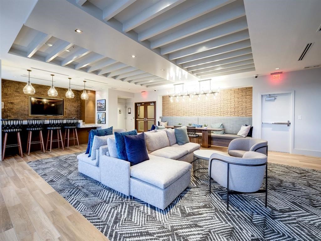 a living room with couches and chairs and a bar at Lincoln Old Town, Alexandria Virginia