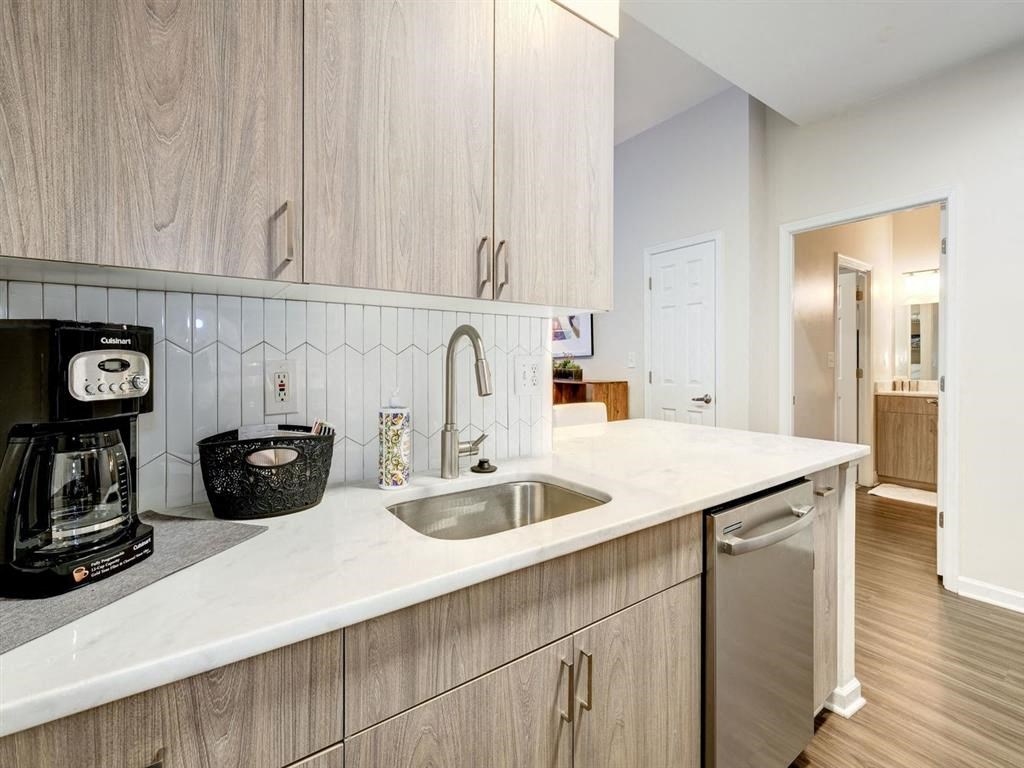 a kitchen with a sink and a counter top at Lincoln Old Town, Alexandria