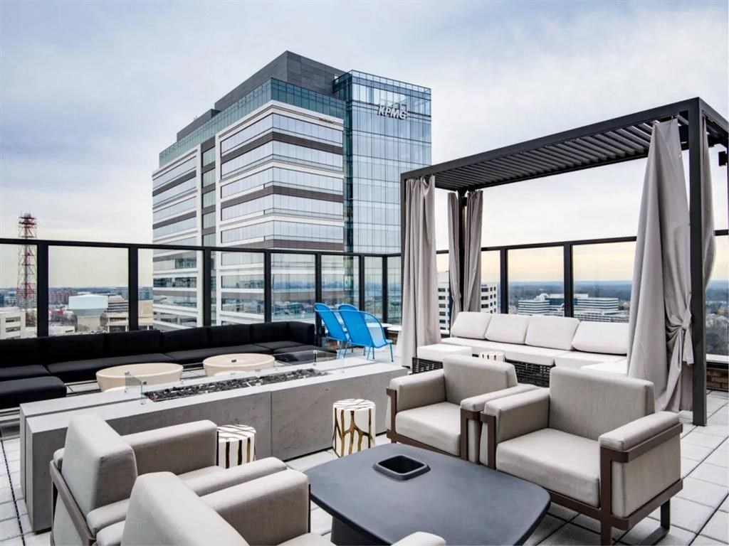 a living room filled with furniture and a fire pit at The Boro, Tysons, VA 22102