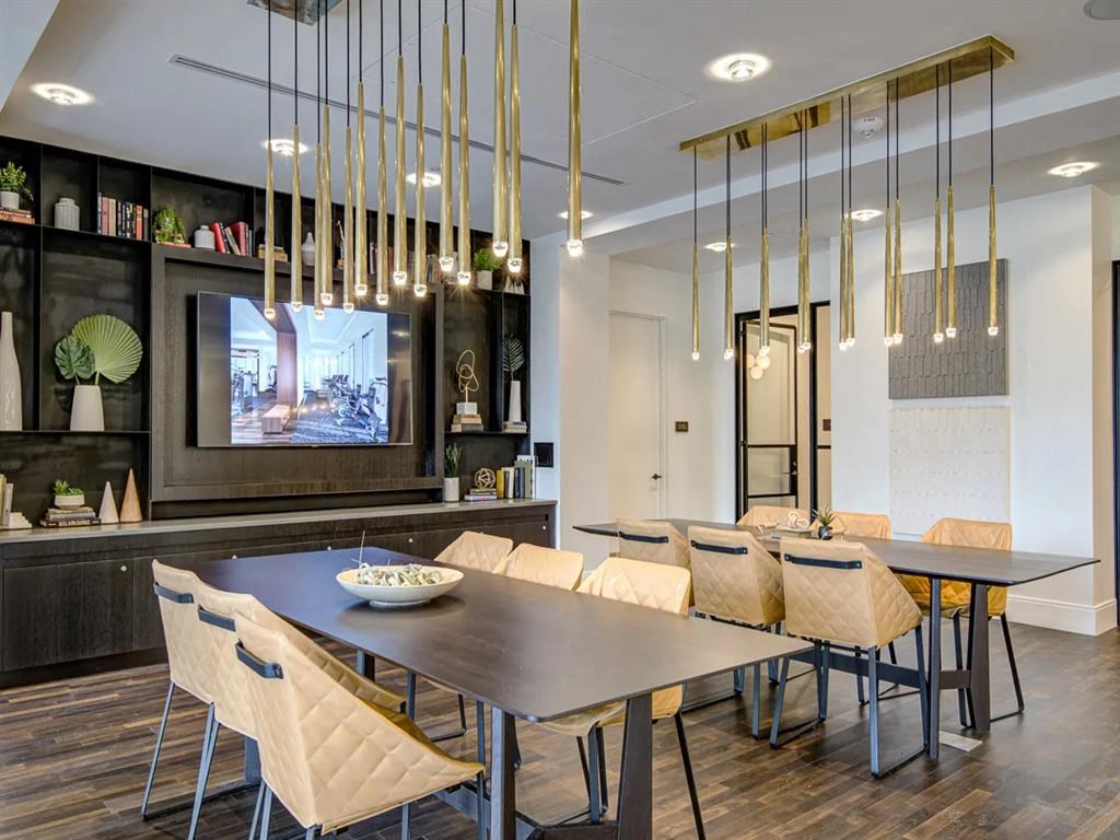 a dining room with a table and chairs and a tv in the background at The Boro, Tysons Virginia
