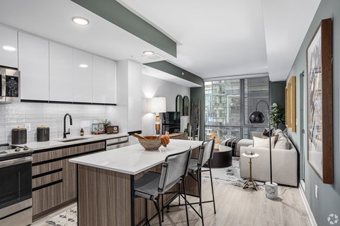 A modern kitchen with white cabinets and a large island.