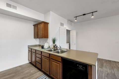 A kitchen with a wooden counter and a black oven.