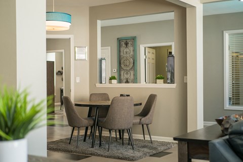 A dining room with a table and chairs at West Park Apartments, Albuquerque