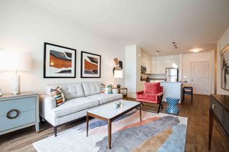 a living room with a couch and a table at Woodmore Grand, Bowie