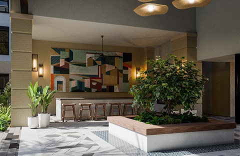a lobby with a tree and a painting on the wall
