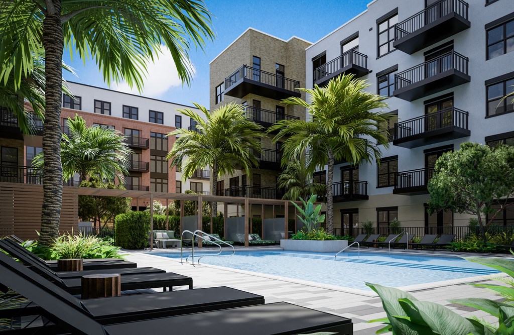 a swimming pool at an apartment complex with palm trees